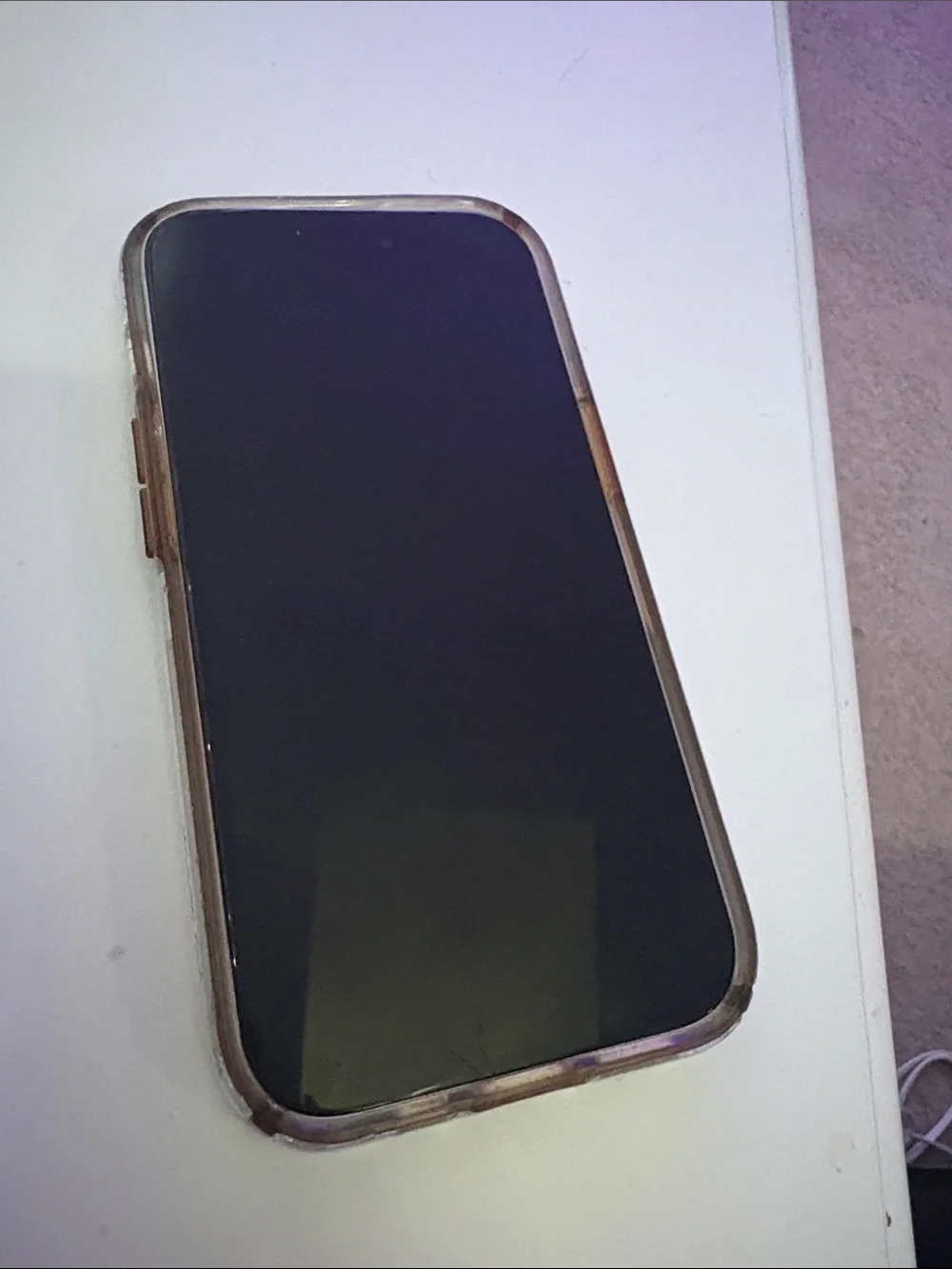 Apple iPhone 15, light blue with clear case.
